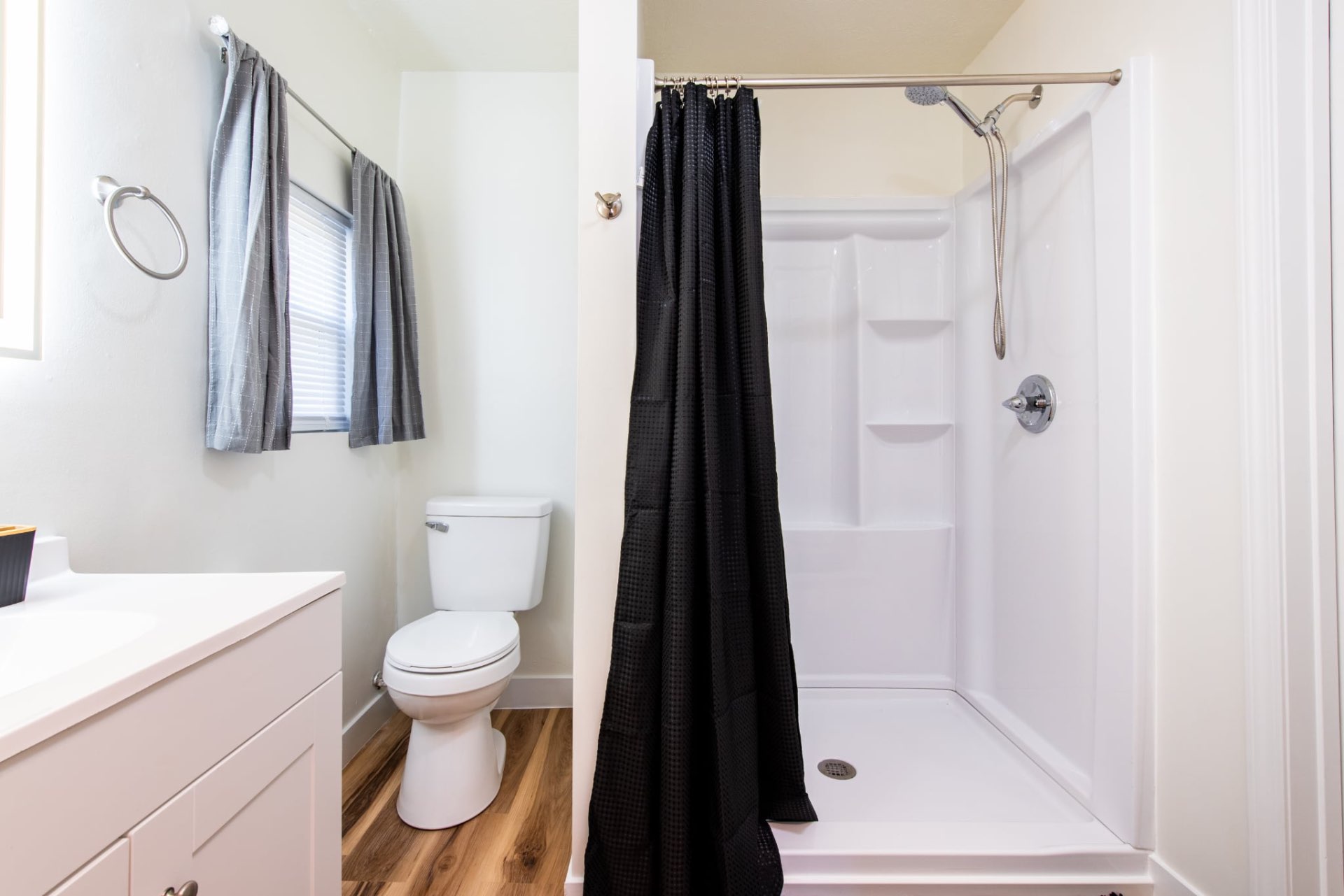 Clean bathroom with vanity and walk-in shower